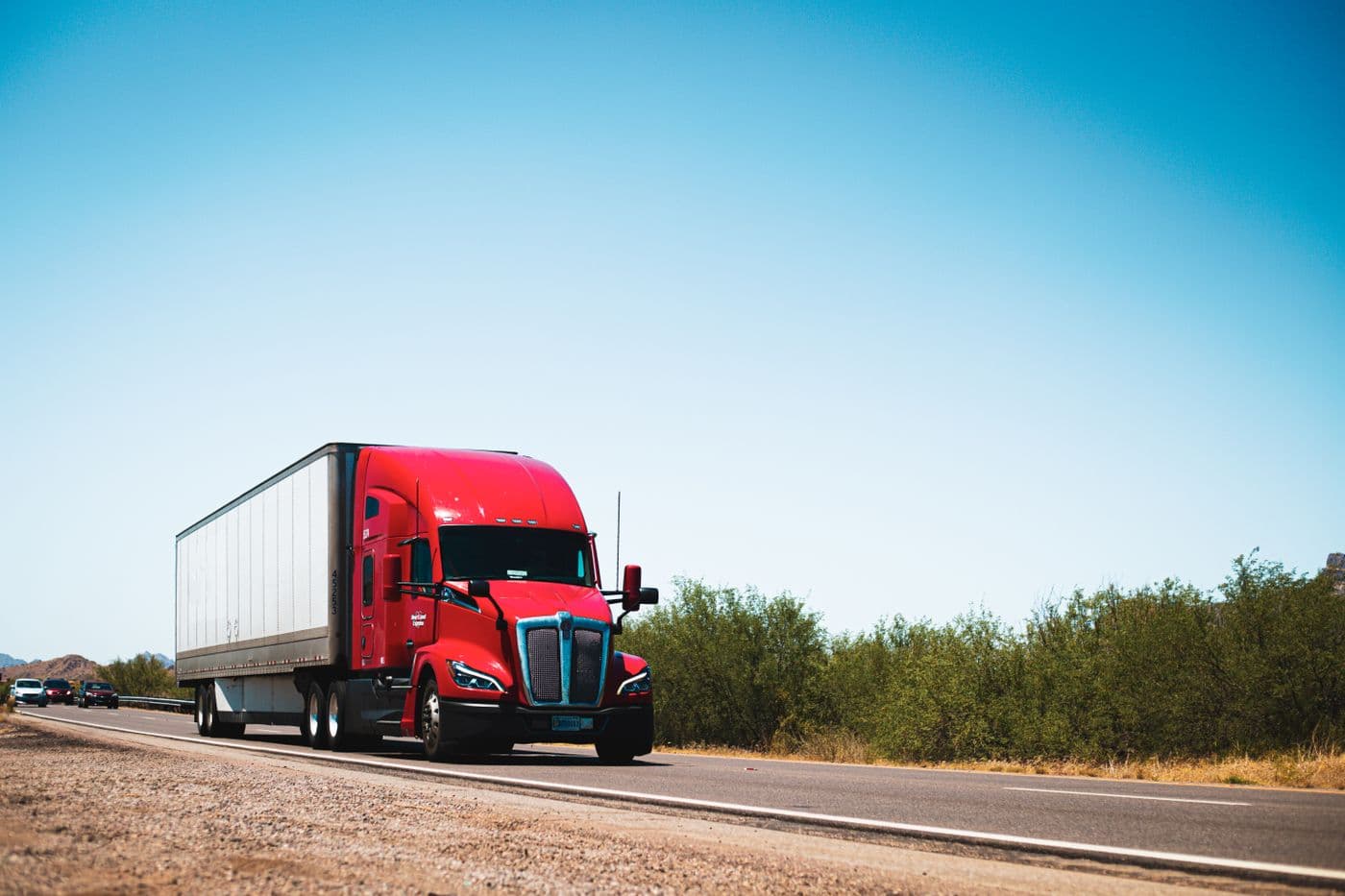 A 53-foot dry van semi-truck running an interstate lane